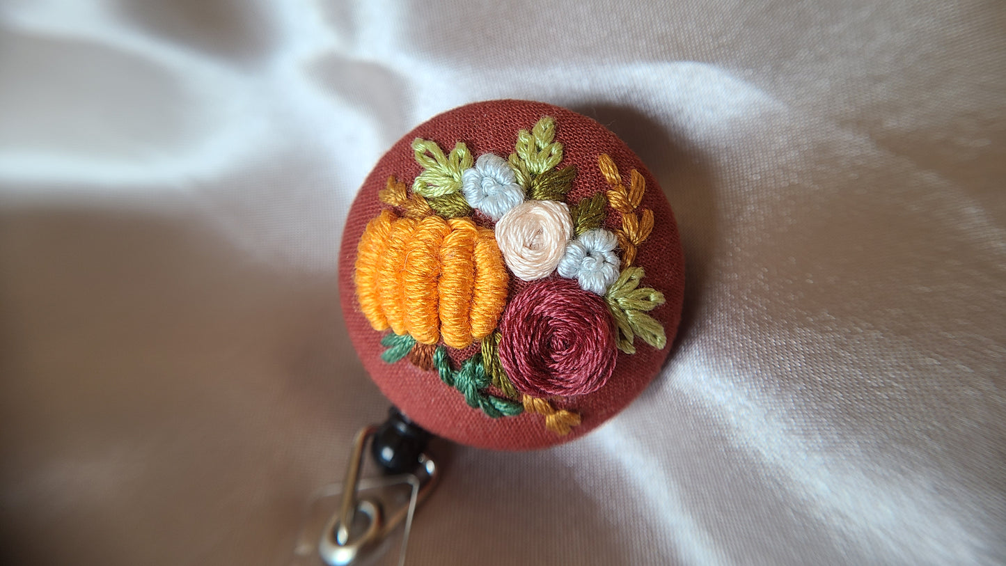 Dusty Pink Rose with Large Orange Pumpkin Wreath on Pumpkin Spice Orange Hand Embroidered Retractable Badge Reel