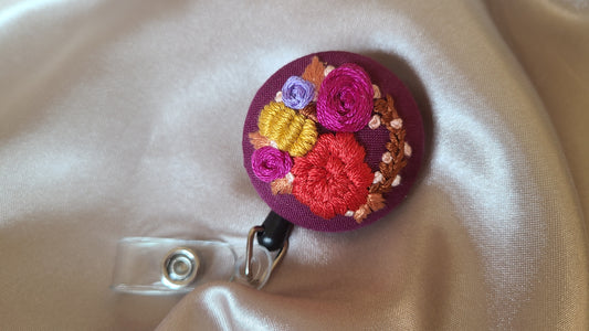 Red and Magenta Floral Wreath with Mini Golden Pumpkin Wreath on Dark Plum Hand Embroidered Retractable Badge Reel - Little Love Parcels