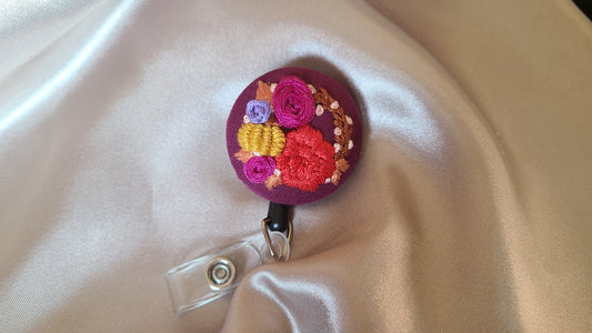 Red and Magenta Floral Wreath with Mini Golden Pumpkin Wreath on Dark Plum Hand Embroidered Retractable Badge Reel - Little Love Parcels