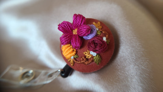 Magenta Petunia with Orange Mini Pumpkin Wreath on Pumpkin Spice Orange Hand Embroidered Retractable Badge Reel - Little Love Parcels
